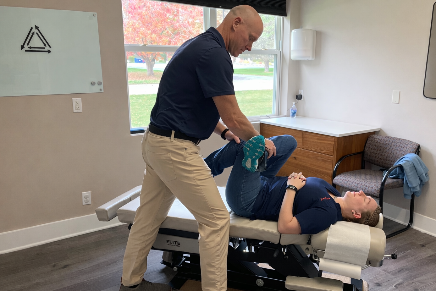 Professional chiropractor providing personalized chiropractic treatment for hip and lower back pain in a private clinic setting